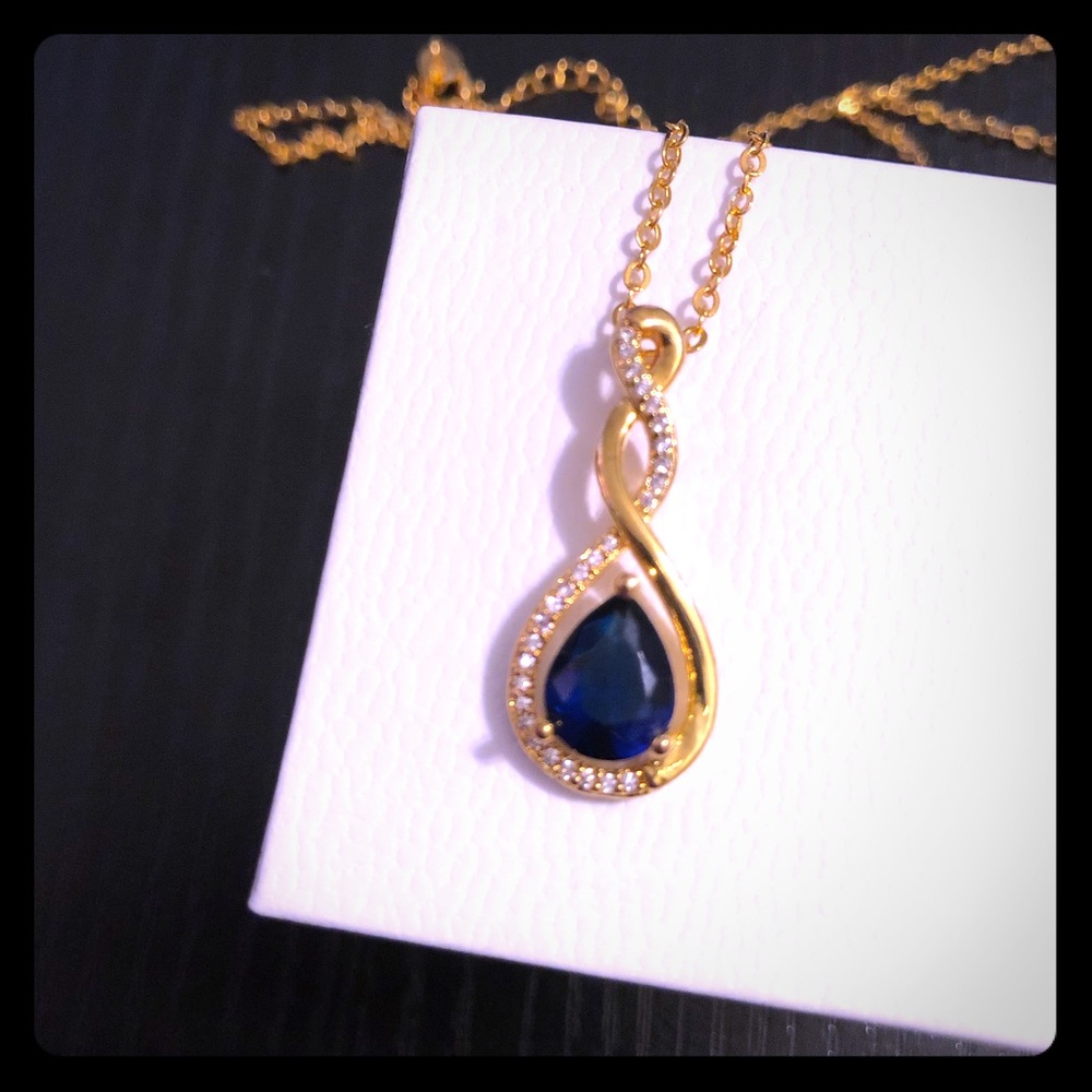 Twisted drop rose gold tone blue stone necklace